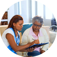 a female caregiver and an elderly woman talking